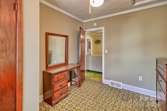 corridor featuring attic access, visible vents, crown molding, and baseboards