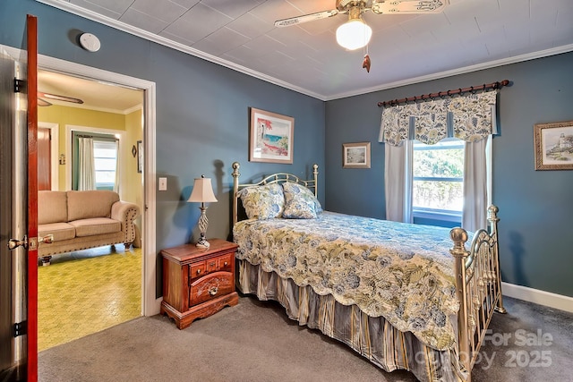 carpeted bedroom featuring ornamental molding, baseboards, and a ceiling fan