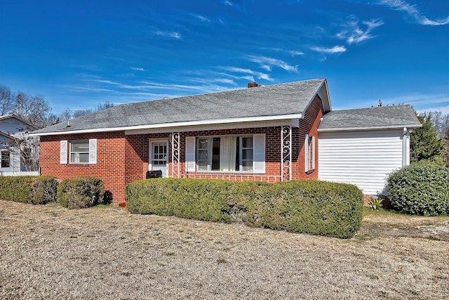 ranch-style house with brick siding and a shingled roof