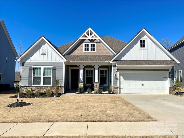 craftsman-style house with a garage, stone siding, concrete driveway, roof with shingles, and board and batten siding