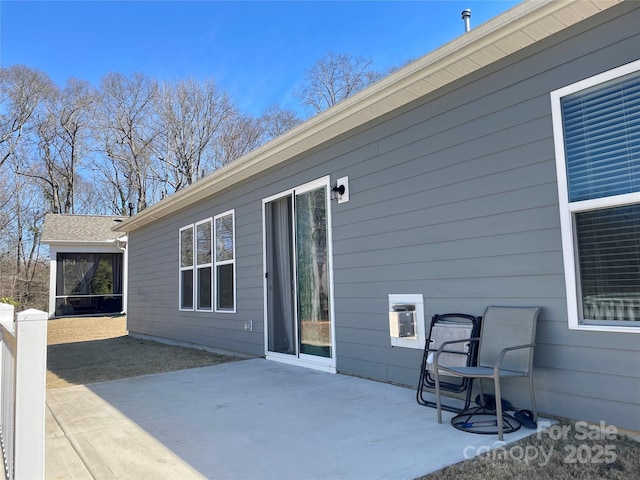 exterior space featuring a patio area and a sunroom