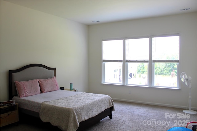 bedroom with carpet floors, baseboards, and visible vents