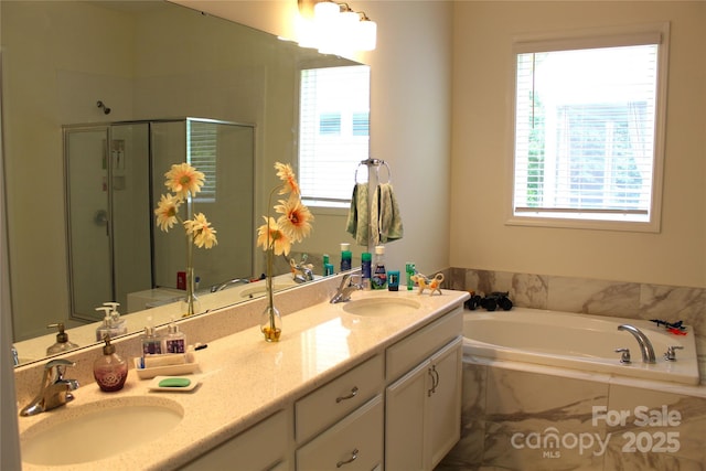 full bath with a stall shower, plenty of natural light, and a sink