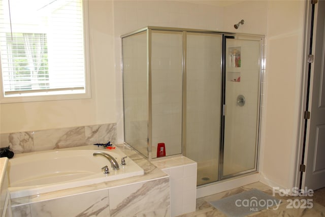 full bathroom featuring a stall shower and a garden tub