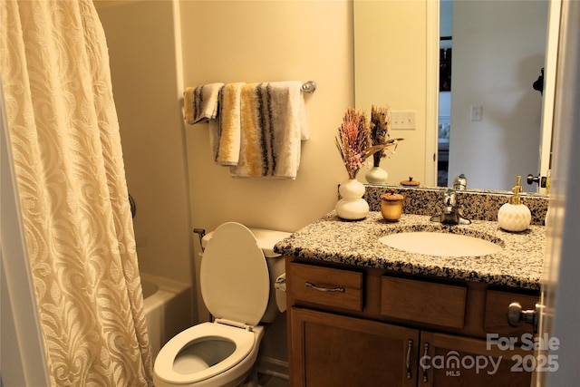 bathroom with toilet, shower / bath combo, and vanity