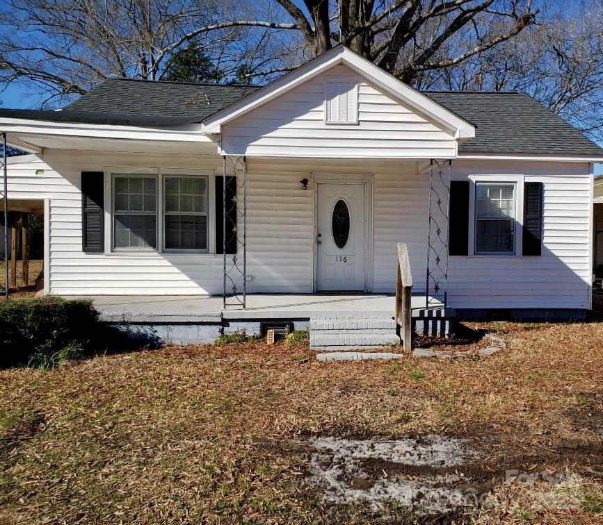 bungalow-style house featuring a porch and roof with shingles