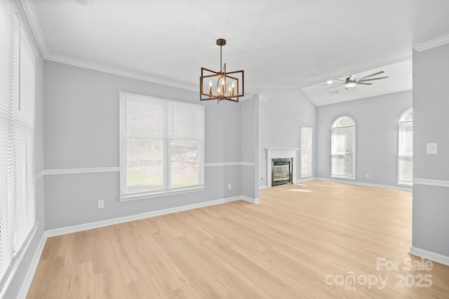 unfurnished living room with a glass covered fireplace, a healthy amount of sunlight, light wood-style flooring, and baseboards