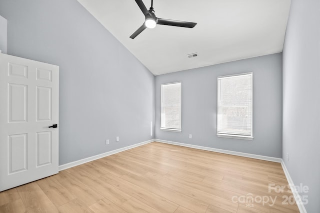 empty room with a ceiling fan, a healthy amount of sunlight, visible vents, and light wood finished floors