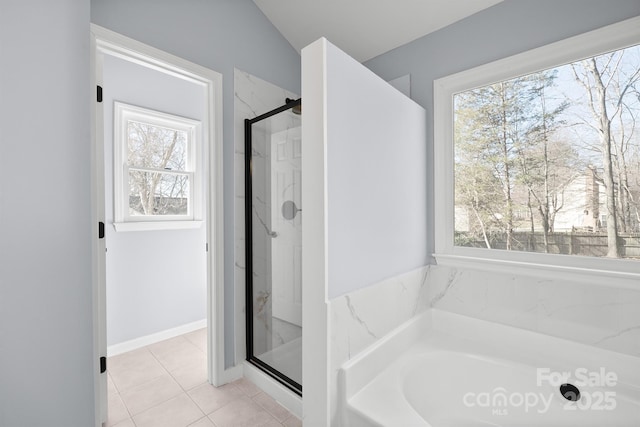 bathroom featuring tile patterned floors, a shower stall, and a bath