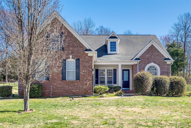 view of front of property with a front lawn and brick siding