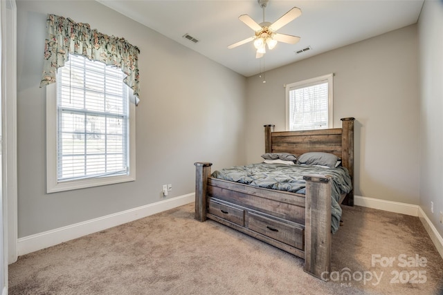 bedroom featuring a ceiling fan, light colored carpet, visible vents, and baseboards