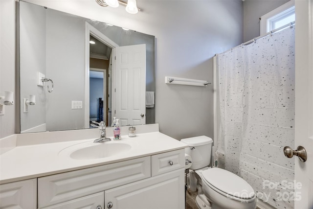 bathroom with toilet, a shower with shower curtain, and vanity