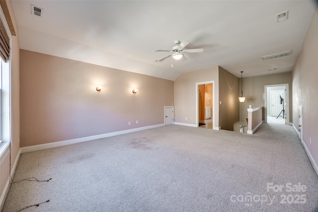 empty room featuring light colored carpet, visible vents, and baseboards