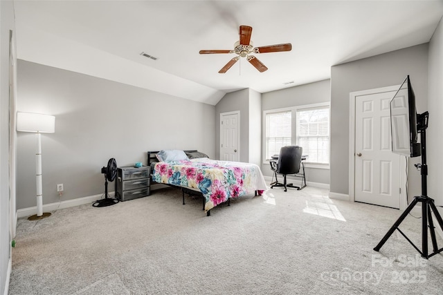 bedroom featuring light carpet, baseboards, visible vents, and vaulted ceiling