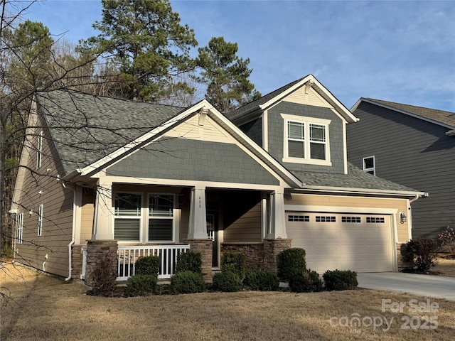 craftsman inspired home featuring driveway, a garage, a shingled roof, stone siding, and covered porch