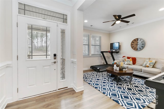 foyer entrance with recessed lighting, wood finished floors, a ceiling fan, baseboards, and ornamental molding