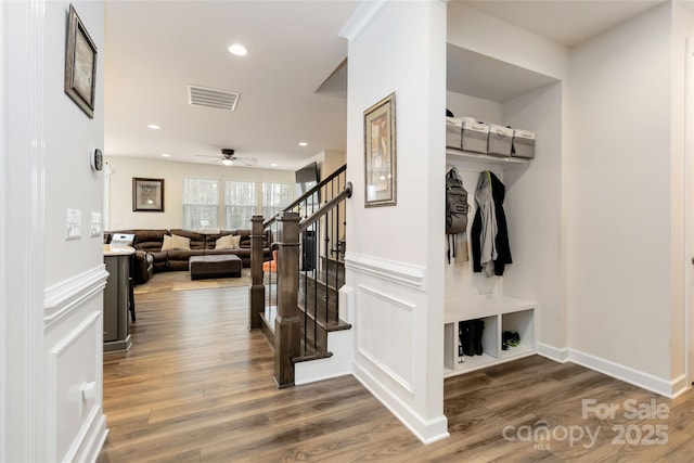 mudroom featuring a decorative wall, a wainscoted wall, recessed lighting, wood finished floors, and visible vents