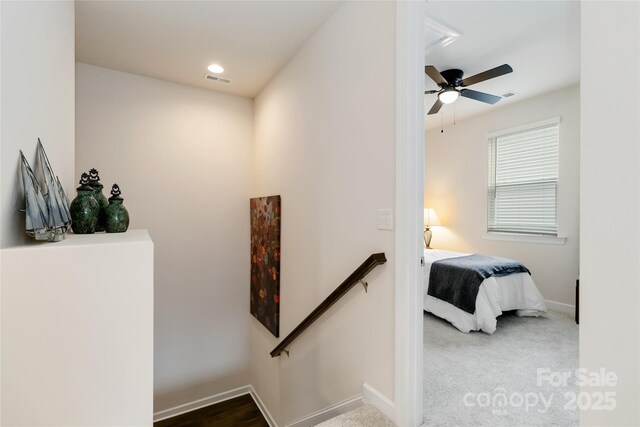 hall featuring carpet, recessed lighting, visible vents, an upstairs landing, and baseboards