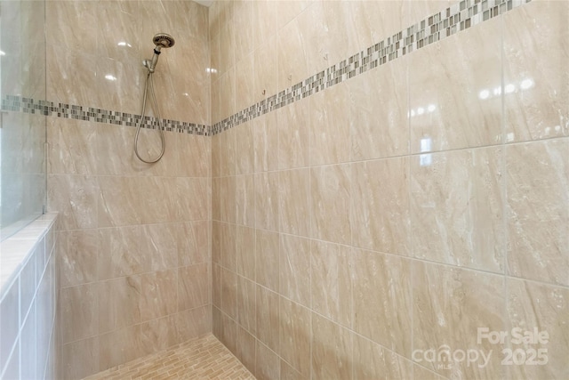 bathroom with tiled shower