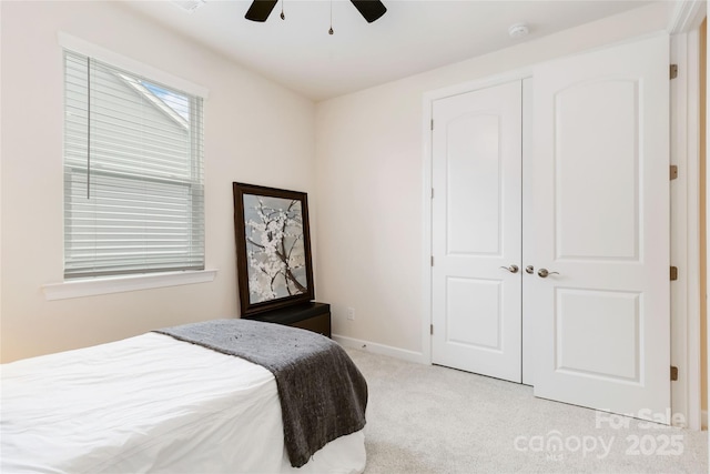 bedroom featuring light carpet, ceiling fan, and baseboards