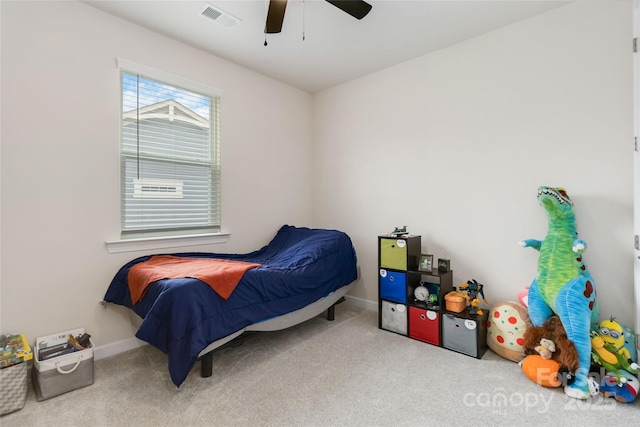 carpeted bedroom featuring baseboards, visible vents, and a ceiling fan