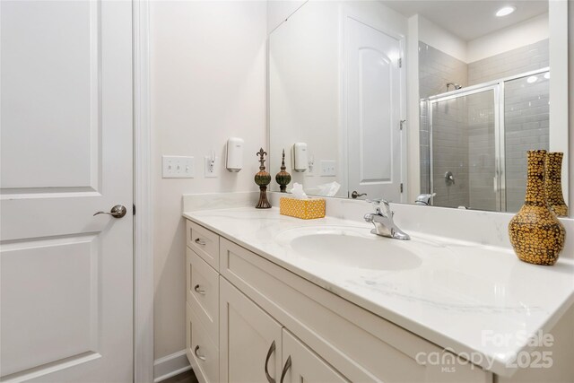 full bath featuring a stall shower and vanity