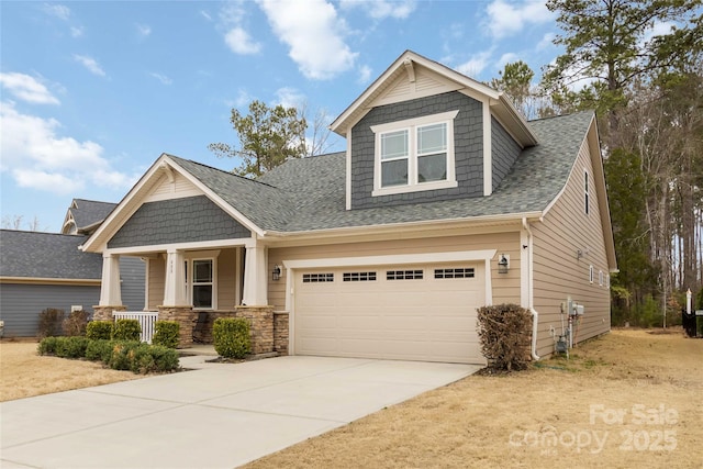 craftsman-style house with concrete driveway, a garage, covered porch, and a shingled roof