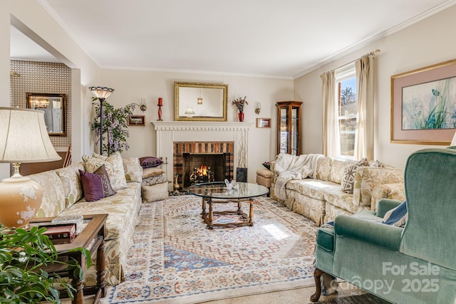 living room with ornamental molding and a fireplace