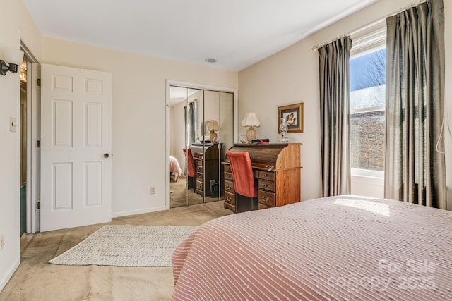 bedroom with carpet floors, a closet, and baseboards