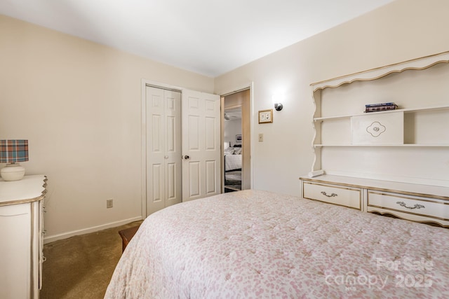 bedroom featuring baseboards, dark carpet, and a closet