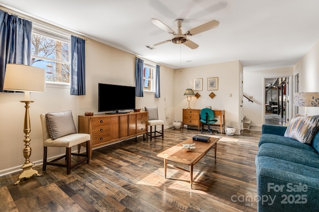 living area featuring visible vents, ceiling fan, baseboards, and wood finished floors