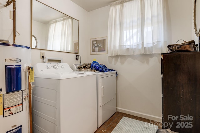 laundry area with washing machine and dryer, laundry area, electric water heater, and baseboards