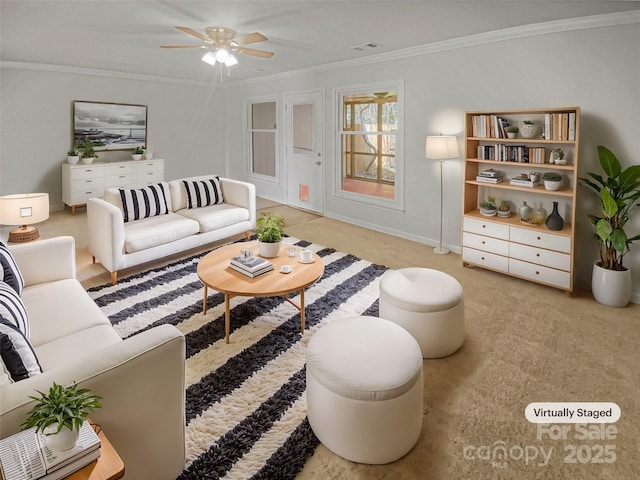 living room with ceiling fan, light colored carpet, visible vents, and crown molding