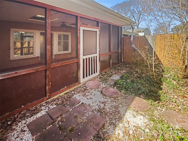 view of yard featuring fence and a sunroom