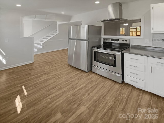 kitchen featuring stainless steel appliances, wood finished floors, dark countertops, and exhaust hood