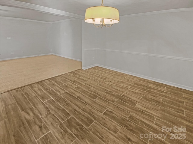 unfurnished dining area with wood tiled floor, crown molding, and baseboards