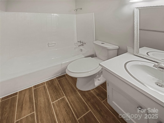 full bathroom featuring toilet, wood tiled floor, bathtub / shower combination, and vanity