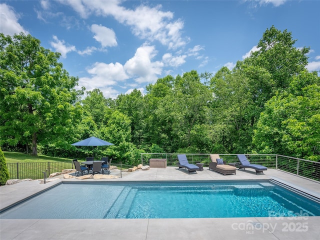 view of swimming pool with a fenced in pool, fence, and a patio