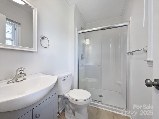 bathroom with tile patterned floors, a shower stall, toilet, and vanity