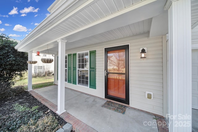 view of exterior entry with a porch