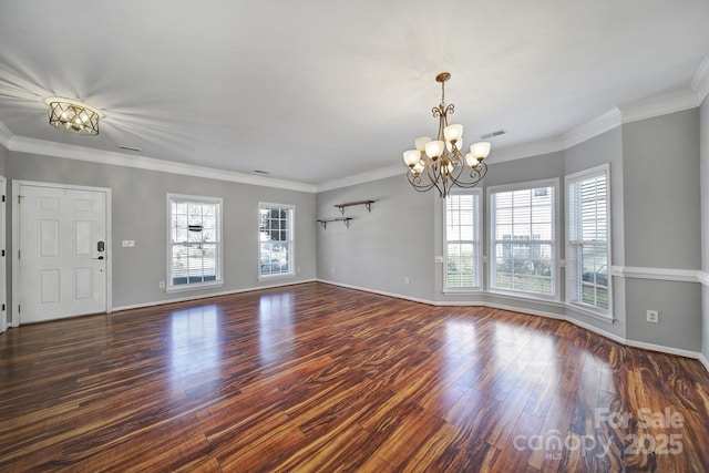 unfurnished living room with wood finished floors, visible vents, baseboards, and an inviting chandelier