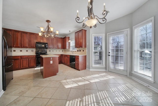 kitchen featuring black appliances, tasteful backsplash, light tile patterned floors, and a chandelier