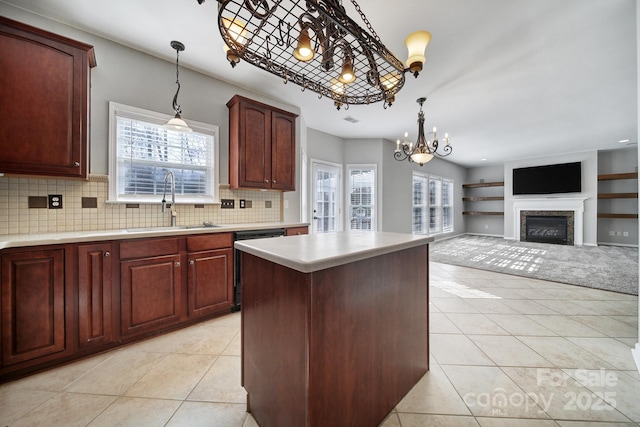 kitchen featuring light tile patterned floors, light countertops, a sink, and dishwasher