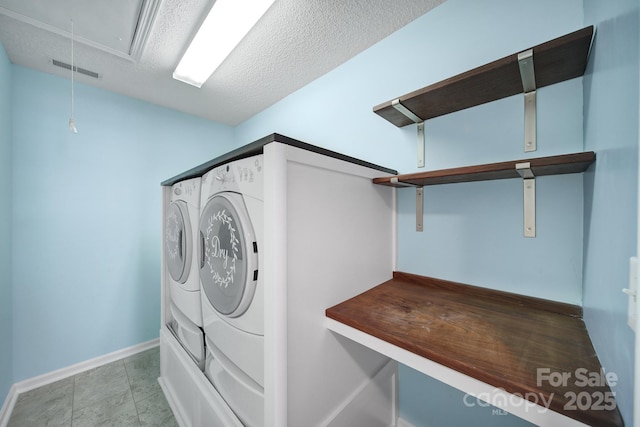 laundry room featuring visible vents, attic access, a textured ceiling, laundry area, and independent washer and dryer