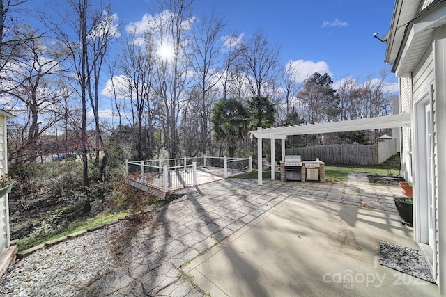 view of patio with fence and a pergola