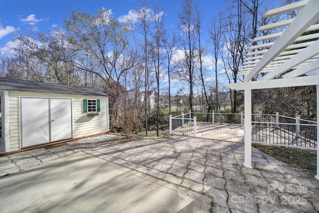 view of patio / terrace with an outbuilding, a storage shed, and a pergola