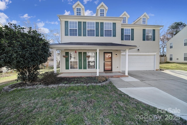 view of front of property featuring driveway, an attached garage, a front lawn, and a porch