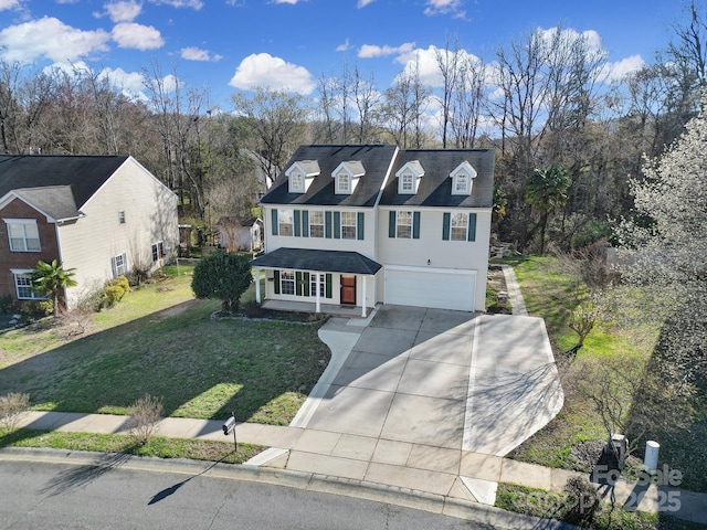 view of front of house with a garage, driveway, and a front lawn