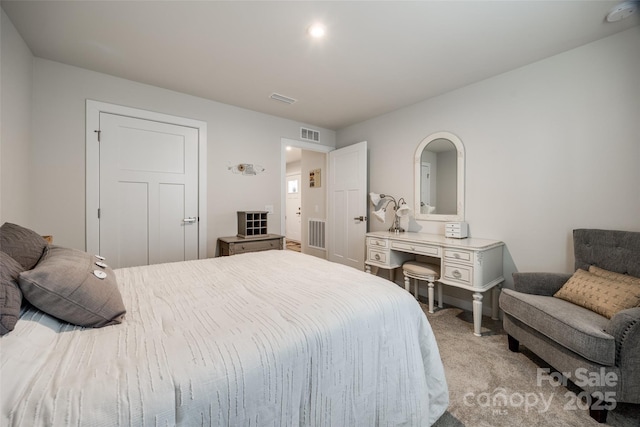 bedroom with visible vents and light colored carpet