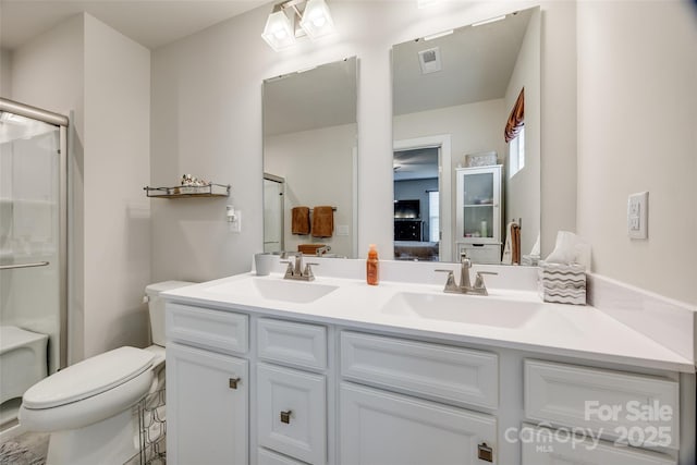 full bathroom with an enclosed shower, a sink, visible vents, and double vanity